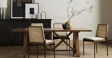 Dining table surrounded by side chairs and sideboard