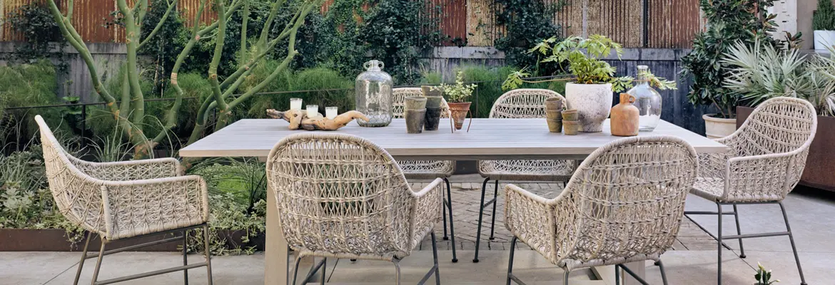 outdoor dining table and arm chairs with decor