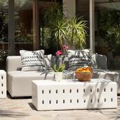 modern outdoor patio furniture set with cushioned seats, a stylish coffee table, and a fruit bowl centerpiece.