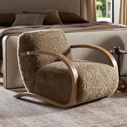 Modern boucle armchair with wooden arms in a cozy bedroom setting.