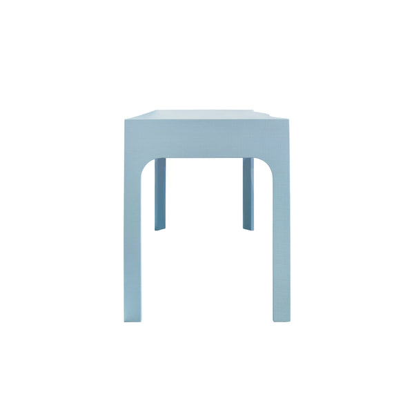 CURVED FRONT DESK WITH THREE DRAWERS IN LIGHT BLUE TEXTURED LINEN WITH SATIN BRASS RING HARDWARE AND GLASS TOP
