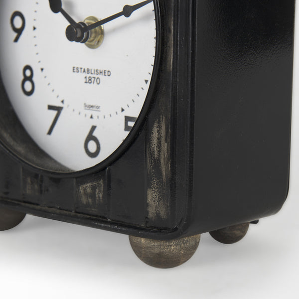 Karl 6.0L x 3.0W x 6.8H Rustic Black Iron Rounded Square Table Clock