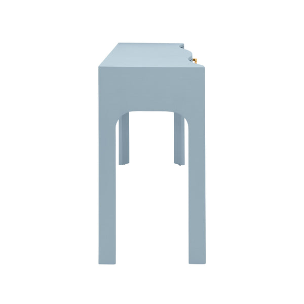 CURVED FRONT CONSOLE WITH THREE DRAWERS IN TEXTURED LIGHT BLUE LINEN WITH SATIN BRASS RING HARDWARE AND GLASS TOP