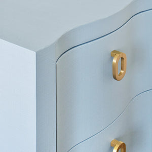 CURVED FRONT SIDE TABLE WITH TWO DRAWERS IN LIGHT BLUE TEXTURED LINEN WITH SATIN BRASS RING HARDWARE