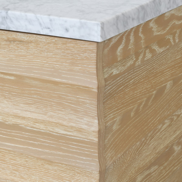 BATH VANITY WITH HORIZONTAL FLUTED DETAIL IN CERUSED OAK WITH WHITE MARBLE TOP, PORCELAIN SINK, AND POLISHED BRASS KNOBS