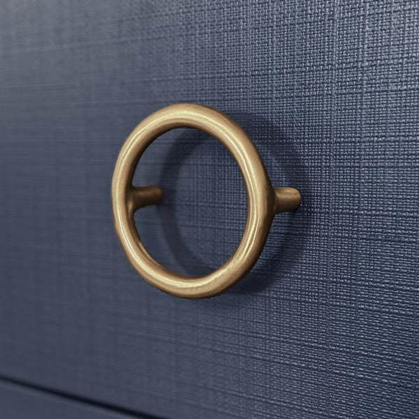 THREE DRAWER CHEST WITH ANTIQUE BRASS CIRCLE HARDWARE IN TEXTURED NAVY LINEN