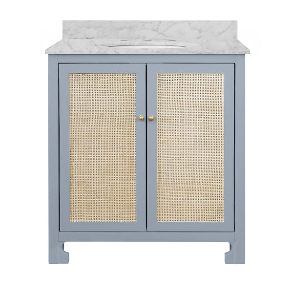 BATH VANITY IN MATTE LIGHT BLUE LACQUER WITH CANE FRONT DOORS, WHITE MARBLE TOP, PORCELAIN SINK, AND POLISHED BRASS KNOBS