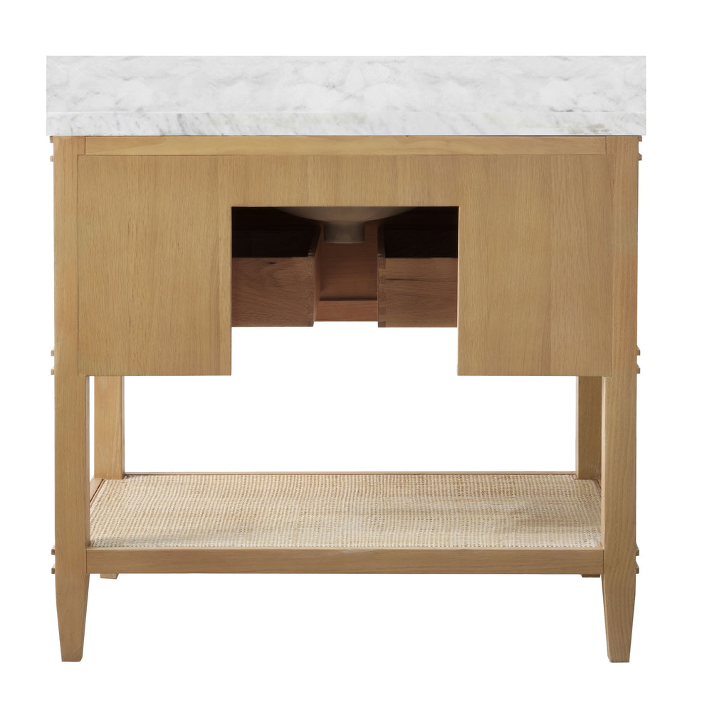 BATH VANITY IN CERUSED OAK WITH OPEN CANE SHELF, WHITE MARBLE TOP, PORCELAIN SINK, AND ANTIQUE BRASS RING HARDWARE