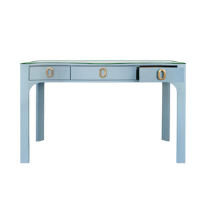 CURVED FRONT DESK WITH THREE DRAWERS IN LIGHT BLUE TEXTURED LINEN WITH SATIN BRASS RING HARDWARE AND GLASS TOP