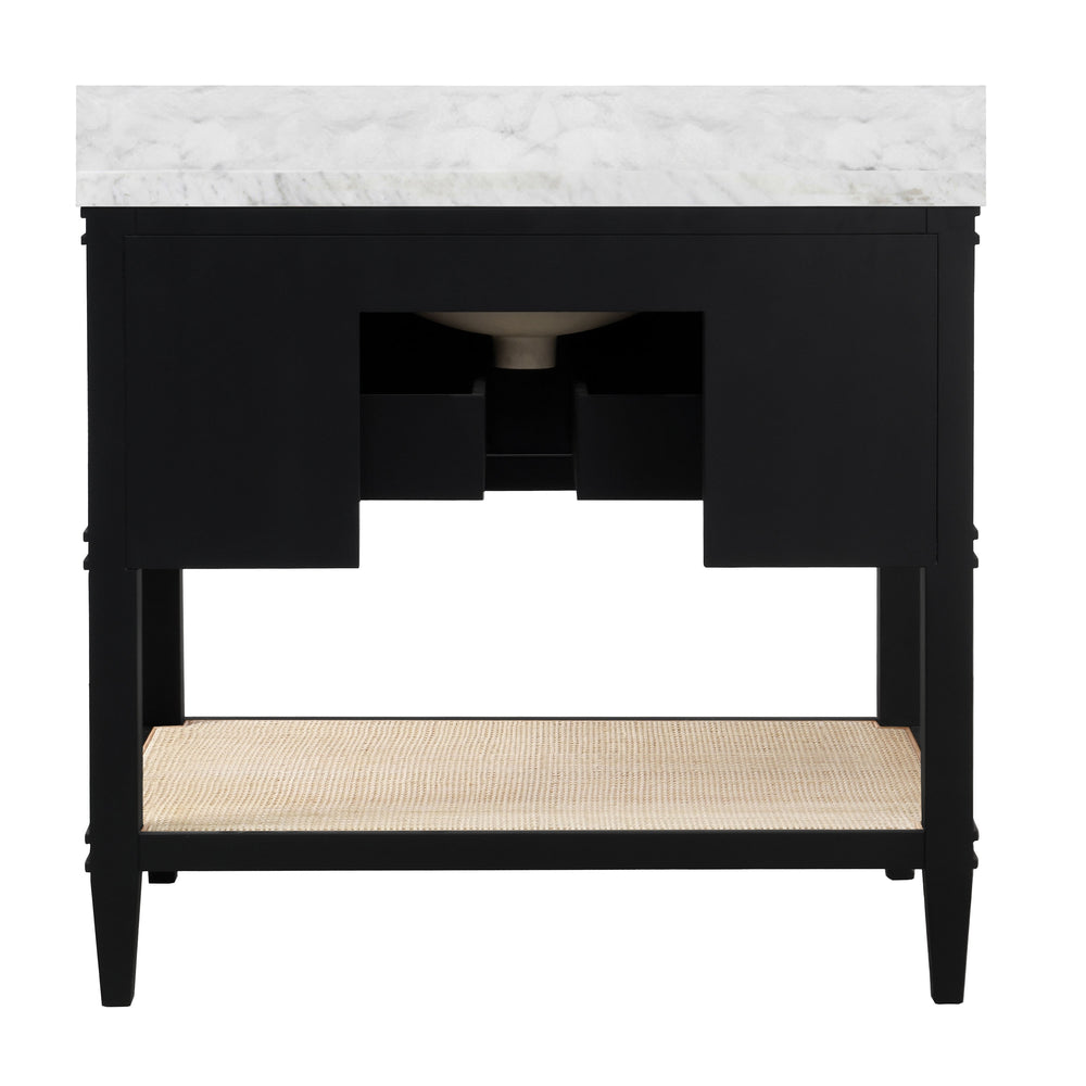 BATH VANITY IN MATTE BLACK LACQUER WITH OPEN CANE SHELF, WHITE MARBLE TOP, PORCELAIN SINK, AND ANTIQUE BRASS RING HARDWARE