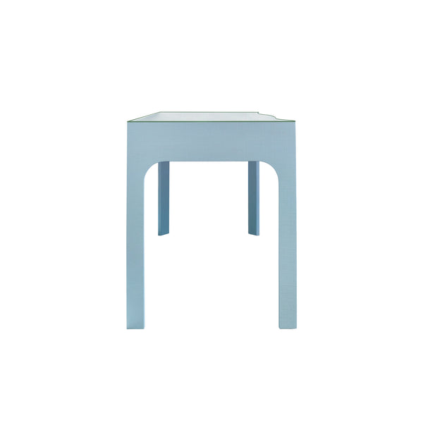CURVED FRONT DESK WITH THREE DRAWERS IN LIGHT BLUE TEXTURED LINEN WITH SATIN BRASS RING HARDWARE AND GLASS TOP
