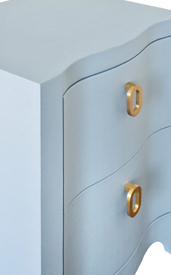 CURVED FRONT SIDE TABLE WITH TWO DRAWERS IN LIGHT BLUE TEXTURED LINEN WITH SATIN BRASS RING HARDWARE