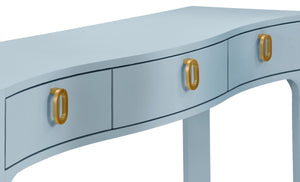 CURVED FRONT CONSOLE WITH THREE DRAWERS IN TEXTURED LIGHT BLUE LINEN WITH SATIN BRASS RING HARDWARE AND GLASS TOP