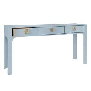 CURVED FRONT CONSOLE WITH THREE DRAWERS IN TEXTURED LIGHT BLUE LINEN WITH SATIN BRASS RING HARDWARE AND GLASS TOP