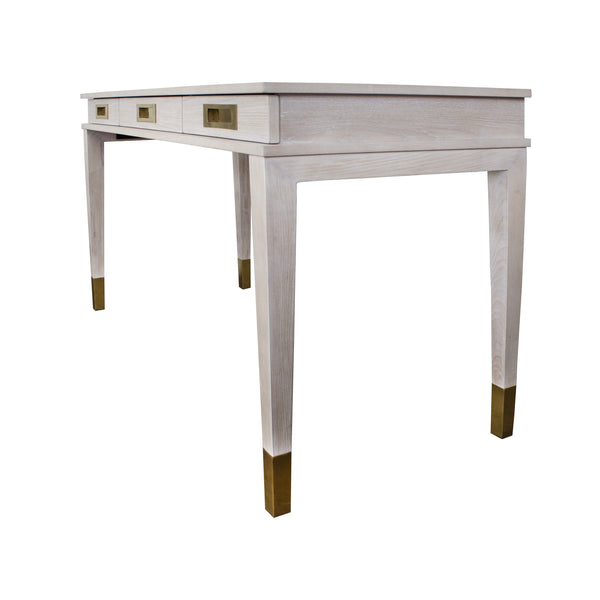 THREE DRAWER DESK WITH BRASS DETAILS IN CERUSED OAK